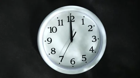 White clock on black background. The second hand goes to 12 o'clock at night Stock Footage 165915177
