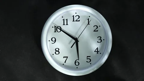White clock on black background. The second hand goes to 6 o'clock. Evening or Stock Footage 167241158