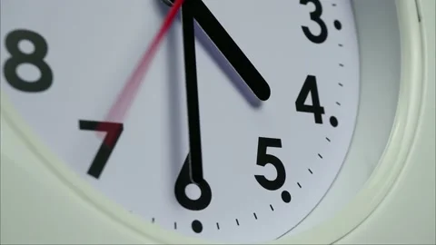 White clock face with clock hands turning by black numbers. Stock Footage 230114719