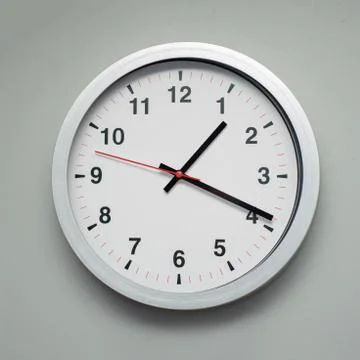 White clock on the gray wall Stock Photos