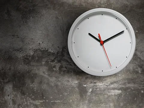 White clock hang isolated on old cement wall background Stock Photos