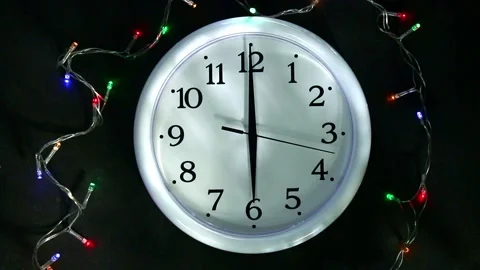 White clock next to garland. The second hand goes to 6 pm. Preparing for the New Stock Footage 166678474