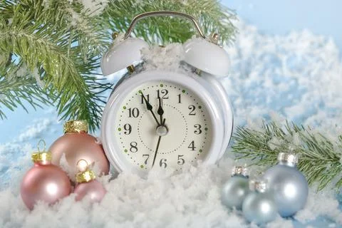 The white clock shows the time 23-55. The last minutes of the outgoing year. Stock Photos
