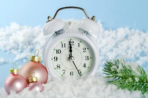 The white clock shows the time 23-55. The last minutes of the outgoing year. Stock Photos