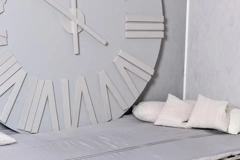 White clock on a white wall. Wall clock on white background, front view Stock Photos