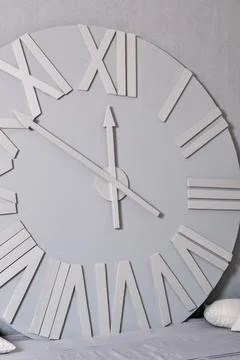 White clock on a white wall. Wall clock on white background, front view Stock Photos