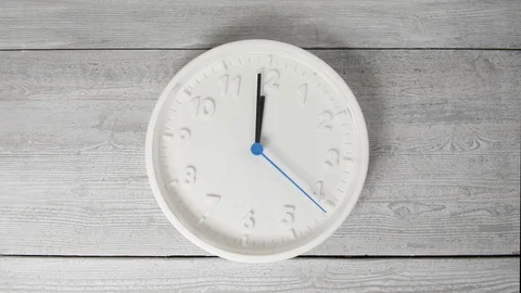 White clock on wooden surface. Moving second hand Stock Footage 124384084