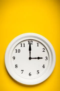 White clock on a yellow background Stock Photos