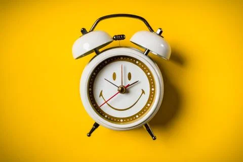 White clock on a yellow background Stock Photos