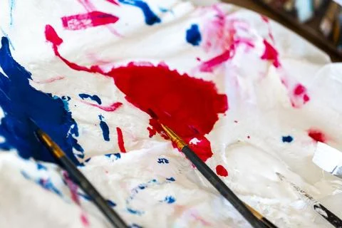 A white cloth that features red, blue, and pink paint splashes on it Stock Photos