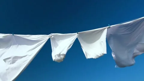 White clothes drying flapping in the yard after being washed clean Stock Footage 336594441
