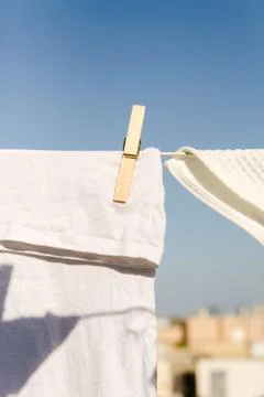 White clothes hung out to dry in the bright warm sun Stock Photos