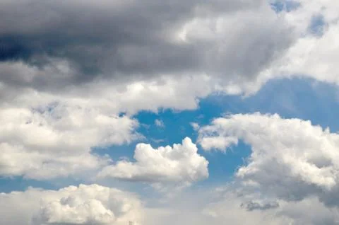 White cloud among dark rain clouds Stock Photos