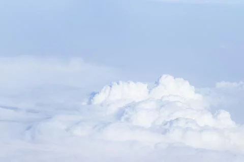 White cloud and blue sky, view through airplane window. Stock Photos