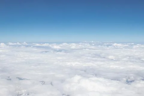 White cloud and blue sky, a view from airplane window Stock Photos