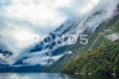 White cloud and high mountain in milford sound fiord land national park new z Stock Photos