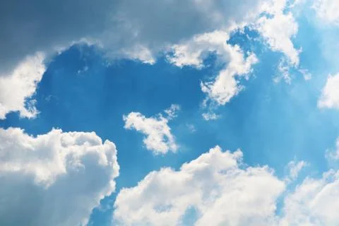 White cloud and sunlight shining and pass on blue sky Stock Photos