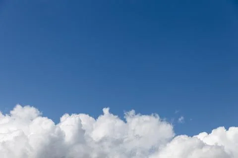 White cloud below on a blue sky Stock Photos