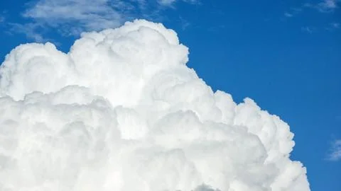 White cloud on a blue sky for a background. Stock Photos