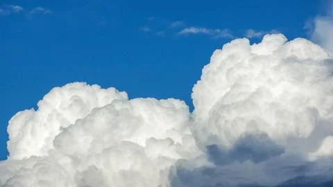 White cloud on a blue sky for a background. Stock Photos