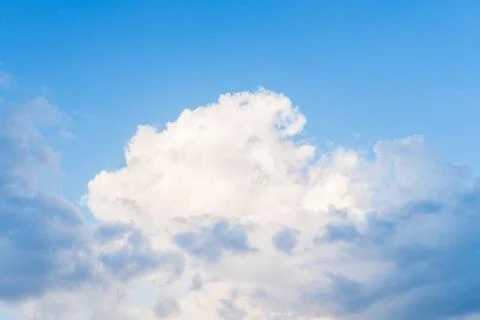 White cloud on a blue sky in clear sunny weather. Stock Photos
