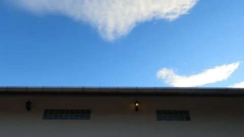 White cloud blue sky  over house rooftop with concrete cement wall Stock Footage 147440194