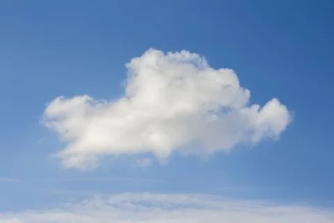 A white cloud in a blue sky Stock Photos