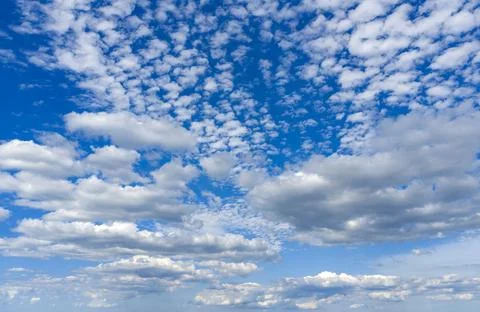White cloud on blue sky. Soft cloud near clear horizon. Fluffy cloud pattern Stock Photos