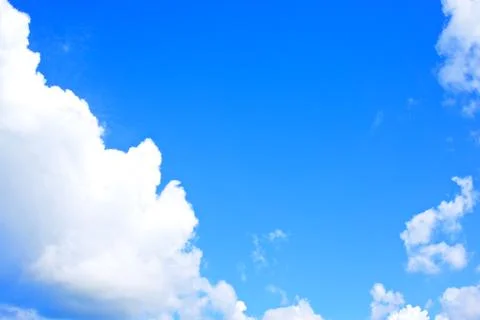 White cloud on bottom left of blue sky Stock Photos