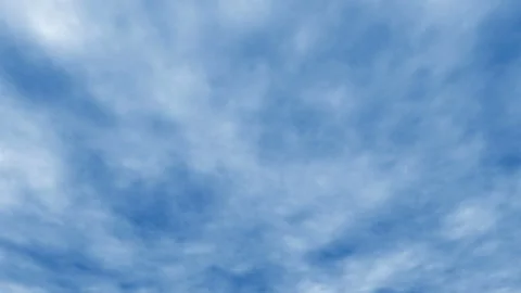 White cloud disappear in the hot sun on blue sky. Cumulus clouds form against a Stock Footage 110885947