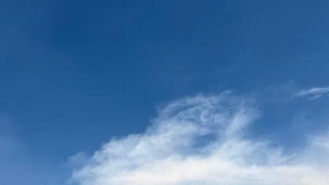 White cloud edges softly meet the crisp blue horizon in the clear sky Фото