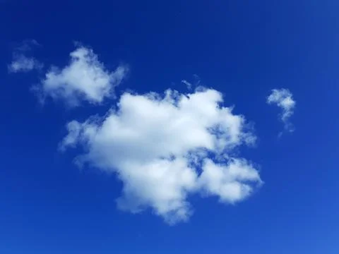 White Cloud Floating in Blue Sky. Cloudscape. Sunny, warm day. Azure sky. Stock Photos