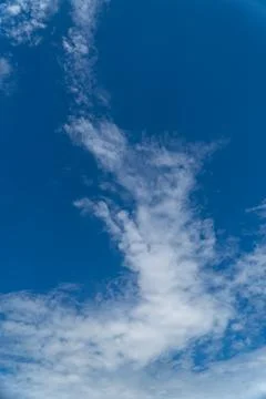 White cloud formation against deep blue sky with copy space 写真素材