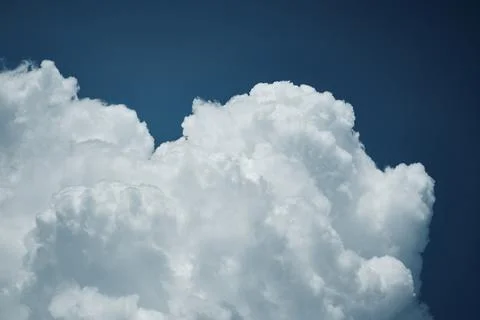 White cloud formation over deep blue sky Stock Photos