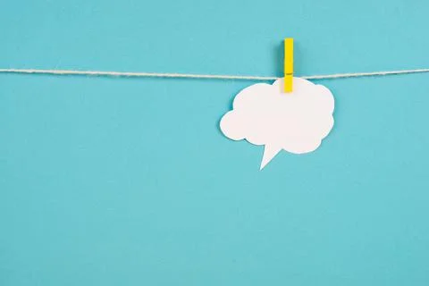 White cloud hanging on a line, empty copy space for text, blue background, commu Stock Photos