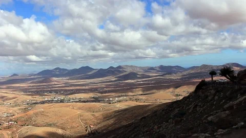White cloud hanging in sky over the volcanic panoramic Canarian landscape Stock Footage 84256416