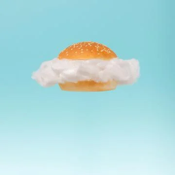 White cloud inside hamburger bun floating against blue sky background. Stockfoto's