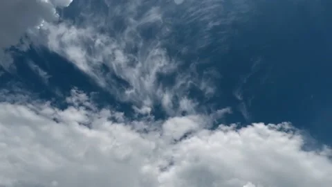 A white cloud moves across the blue clear sky Stock Footage 229767902