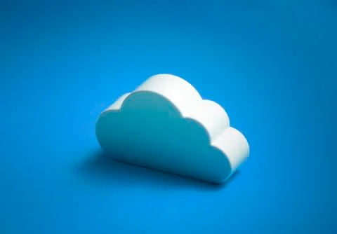 White cloud shape over blue background Stock Photos
