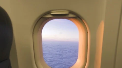 White cloud in sky view from airplane window while golden sunrise. View from Stock Footage 104566109