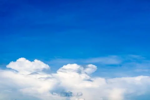 White cloud in summer clear blue sky over the ocean Stock Photos