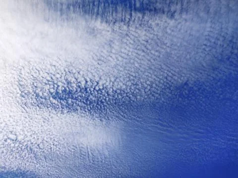 White clouds against the background of a blue sky Stock Photos