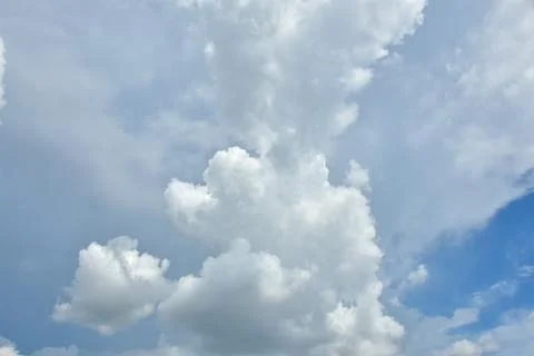 White clouds against blue sky for a backgrounds. Stock Photos