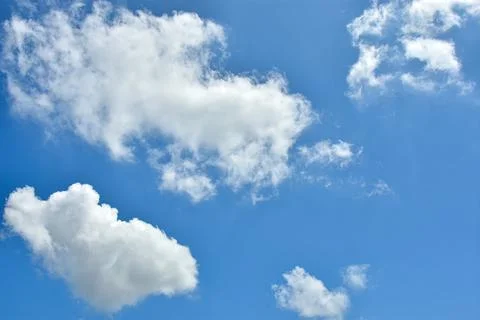 White clouds against blue sky for a backgrounds. Stock Photos