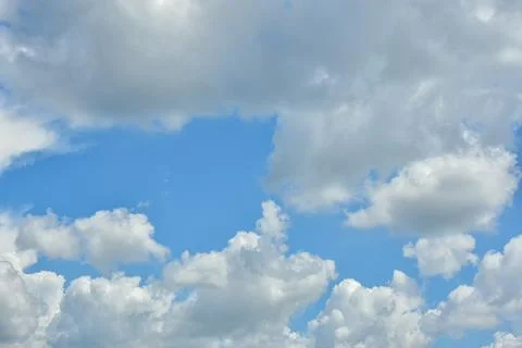 White clouds against blue sky for a backgrounds. Stock Photos
