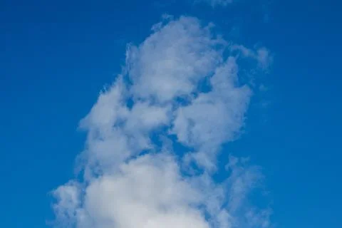 White Clouds Against a Bright Blue Sky Stock Photos