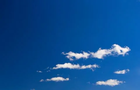 White clouds against a deep blue sky Stock Photos