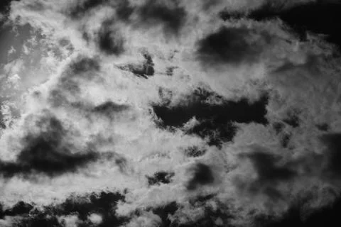 White clouds against a dramatic black sky, background Stock Photos