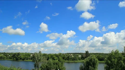 White clouds and blue sky over the river timelapse Stock Footage 26049560