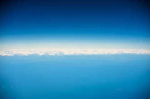 White clouds and blue sky seen from airplane Stock Photos